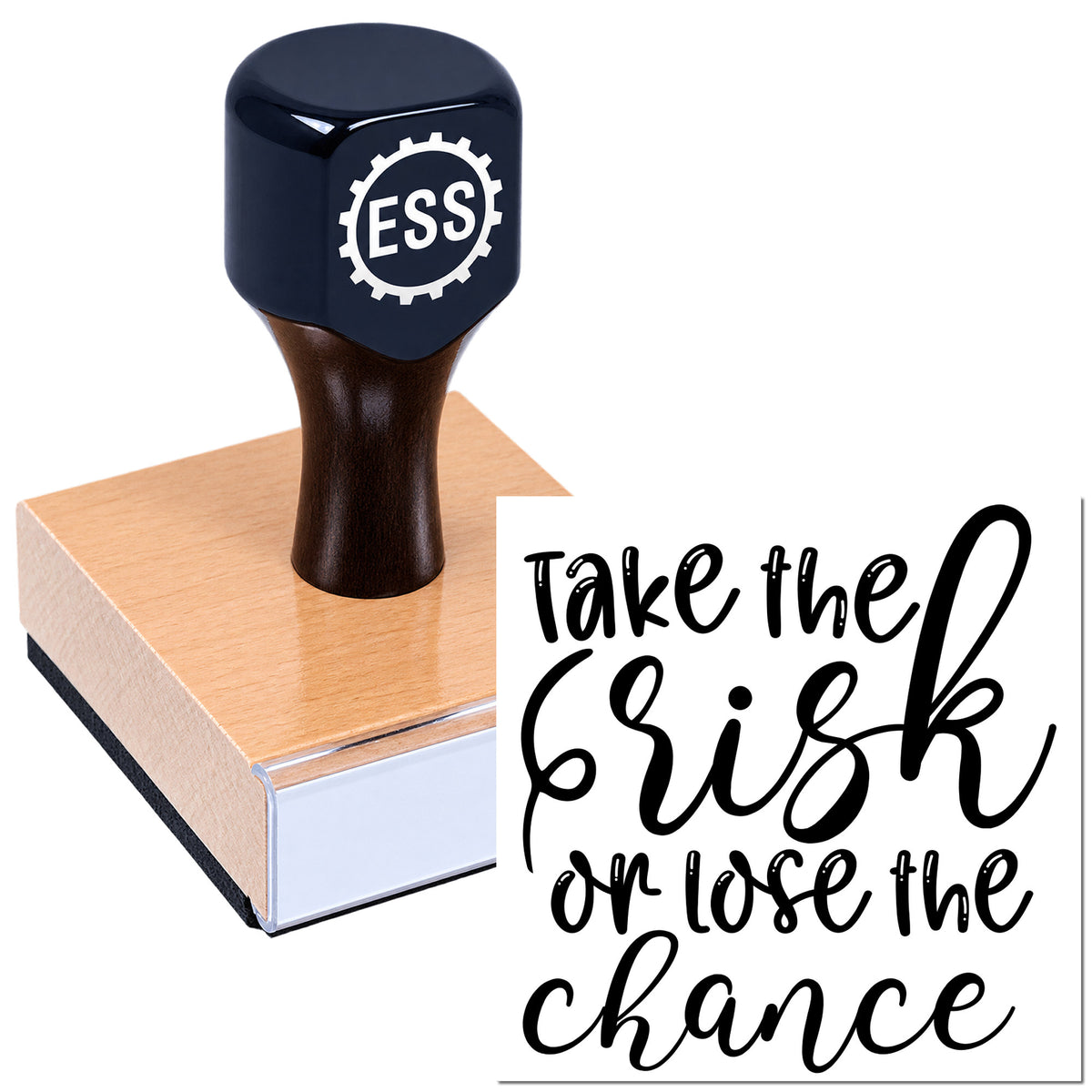 Dark navy ESS rubber seal stamp on a rose-gold wooden block beside black script text: "Take the risk or lose the chance."