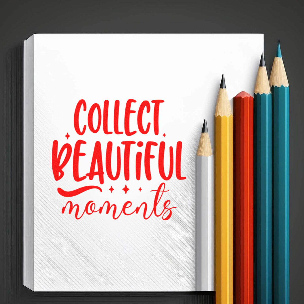 Red Collect Beautiful moments stamp-style design on white pad with colored pencils and seal-inspired lettering.