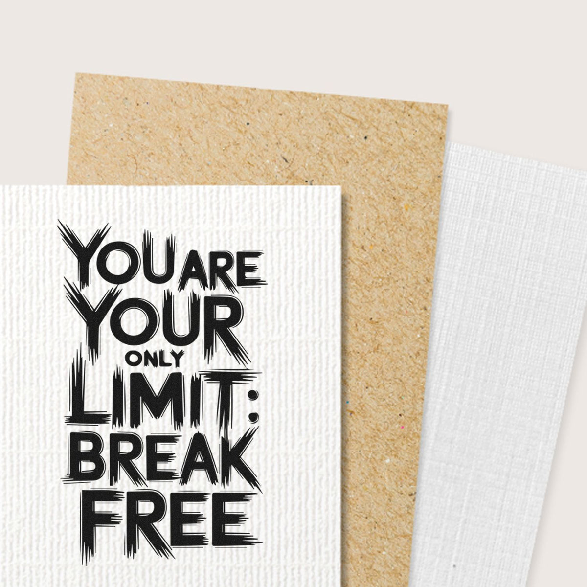 Black motivational stamp and seal sample on white textured paper, layered over tan kraft and white fabric swatches.