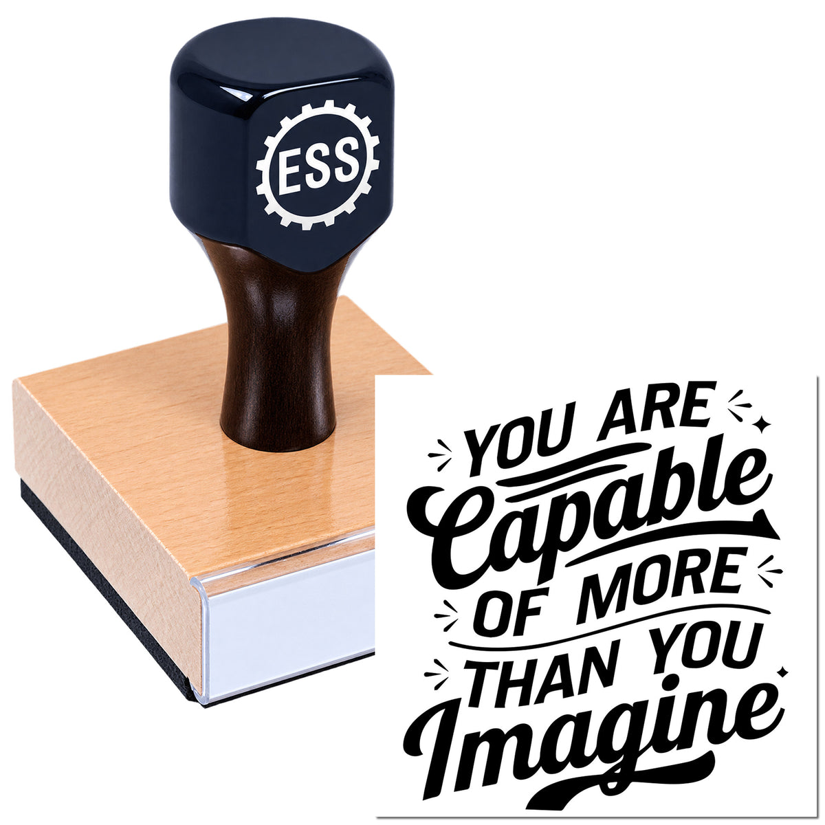 Black ESS rubber stamp and seal on a pink wooden base with "You Are Capable of More Than You Imagine" imprint.