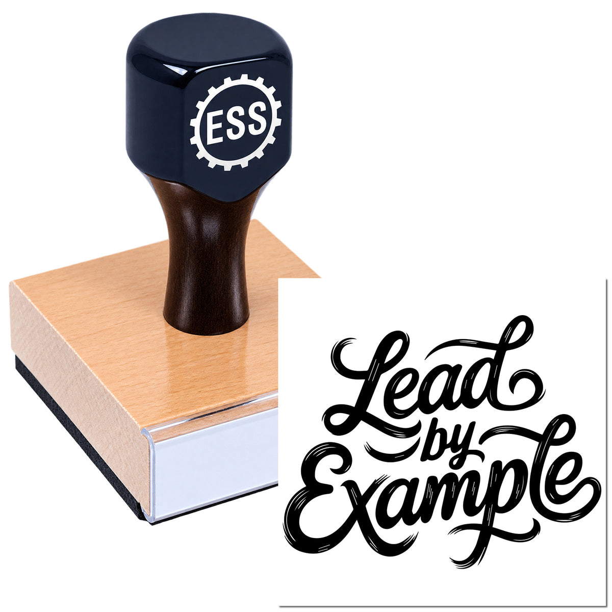 Black ESS seal stamp on a copper and white wooden block with "Lead by Example" script design.