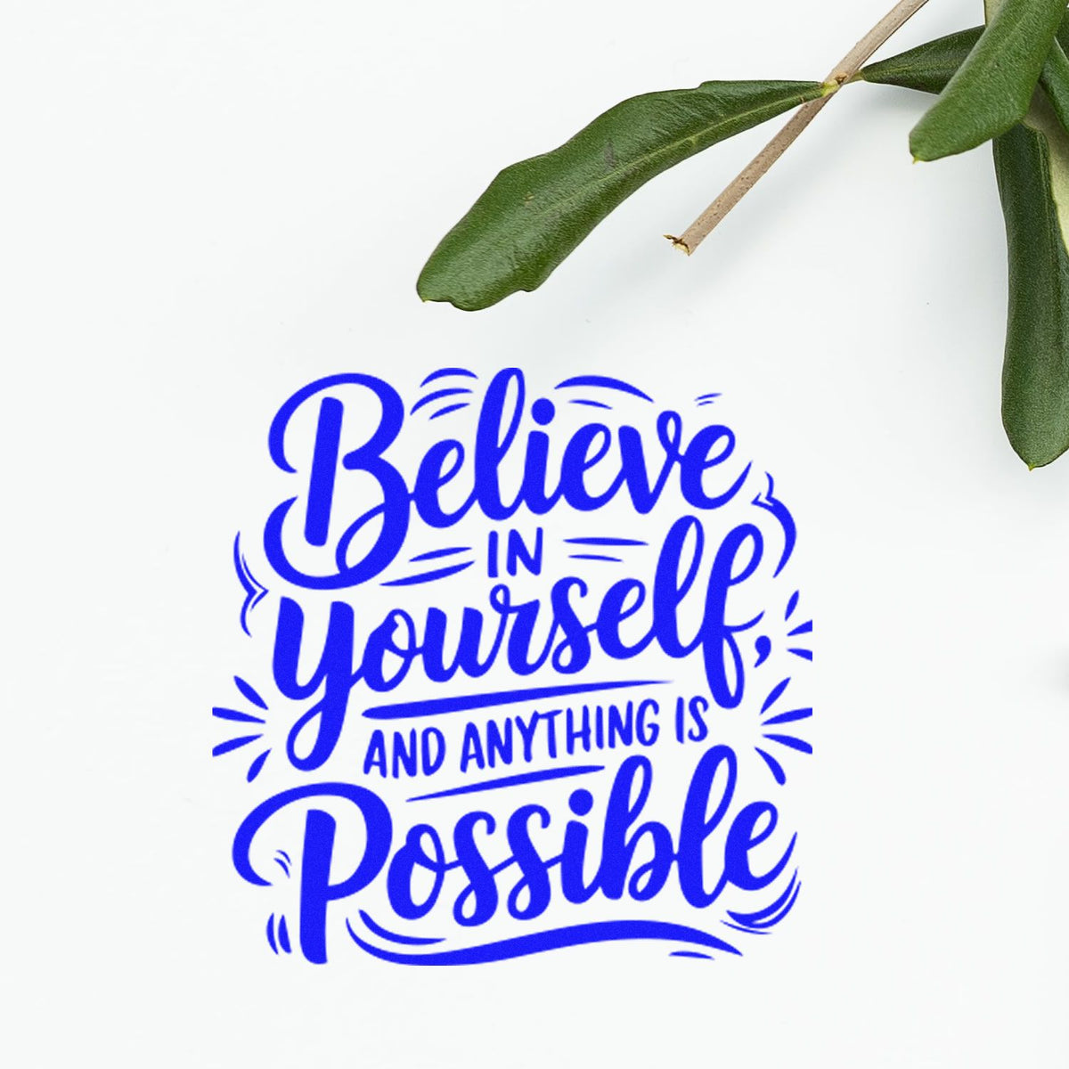 Blue rubber stamp seal reading Believe in yourself and anything is possible, with green leaves on white background