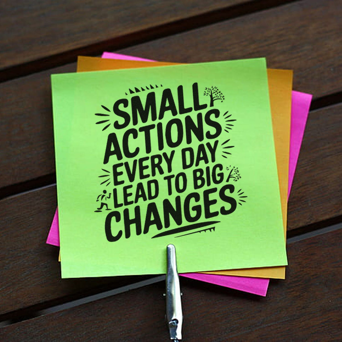 Green stamp and seal card with black Small actions
slogan, layered over pink and orange notes.