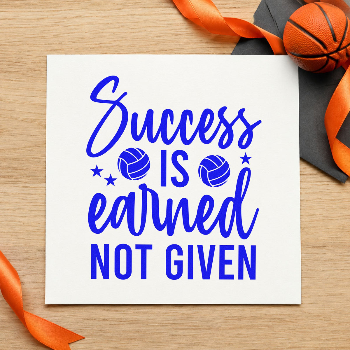 Success Earned Not Given craft stamp in blue ink on cardstock, an easy option for beach towel printing.