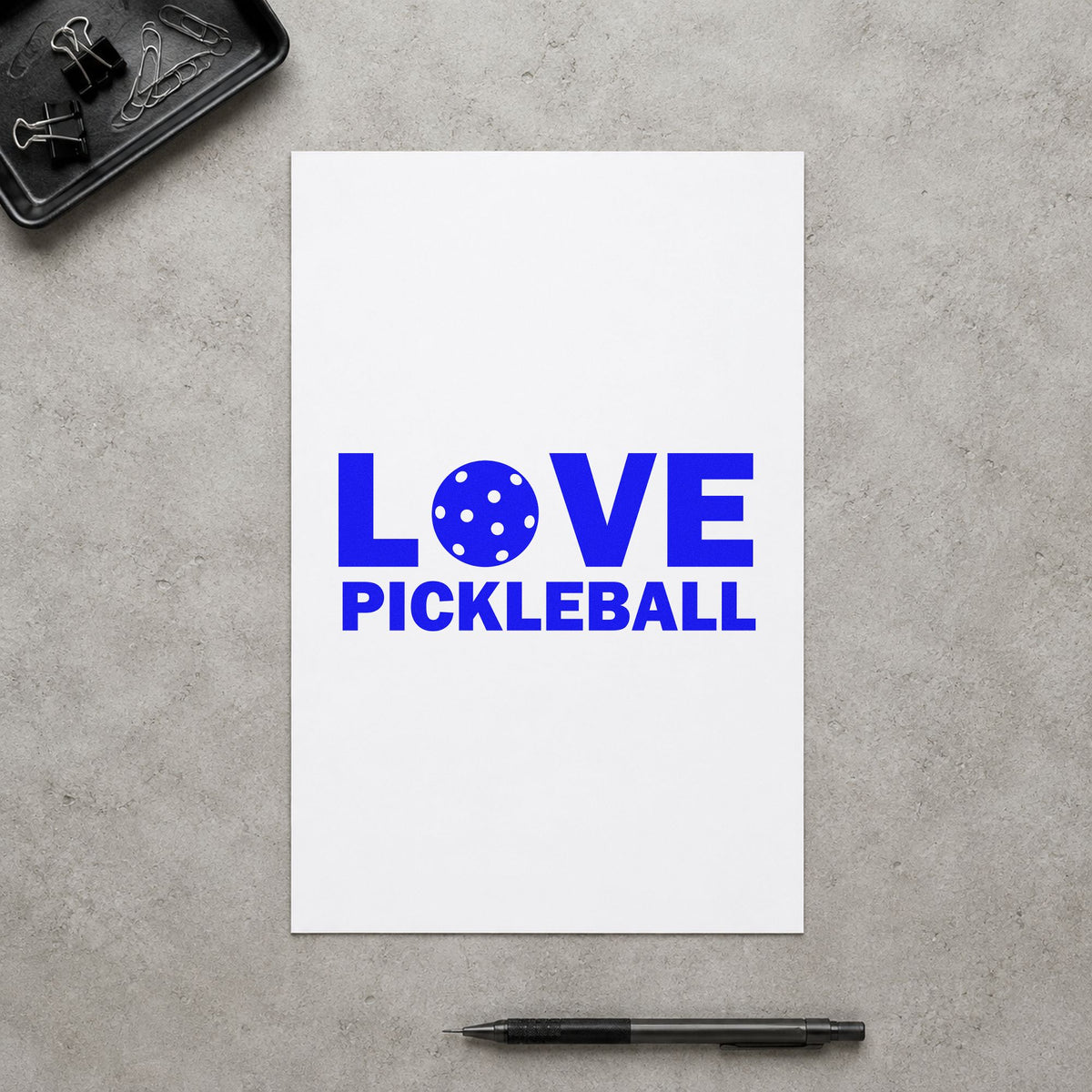 Love Pickleball Ball Letter craft stamp imprinted in blue ink on paper, a design suited to framed court post.