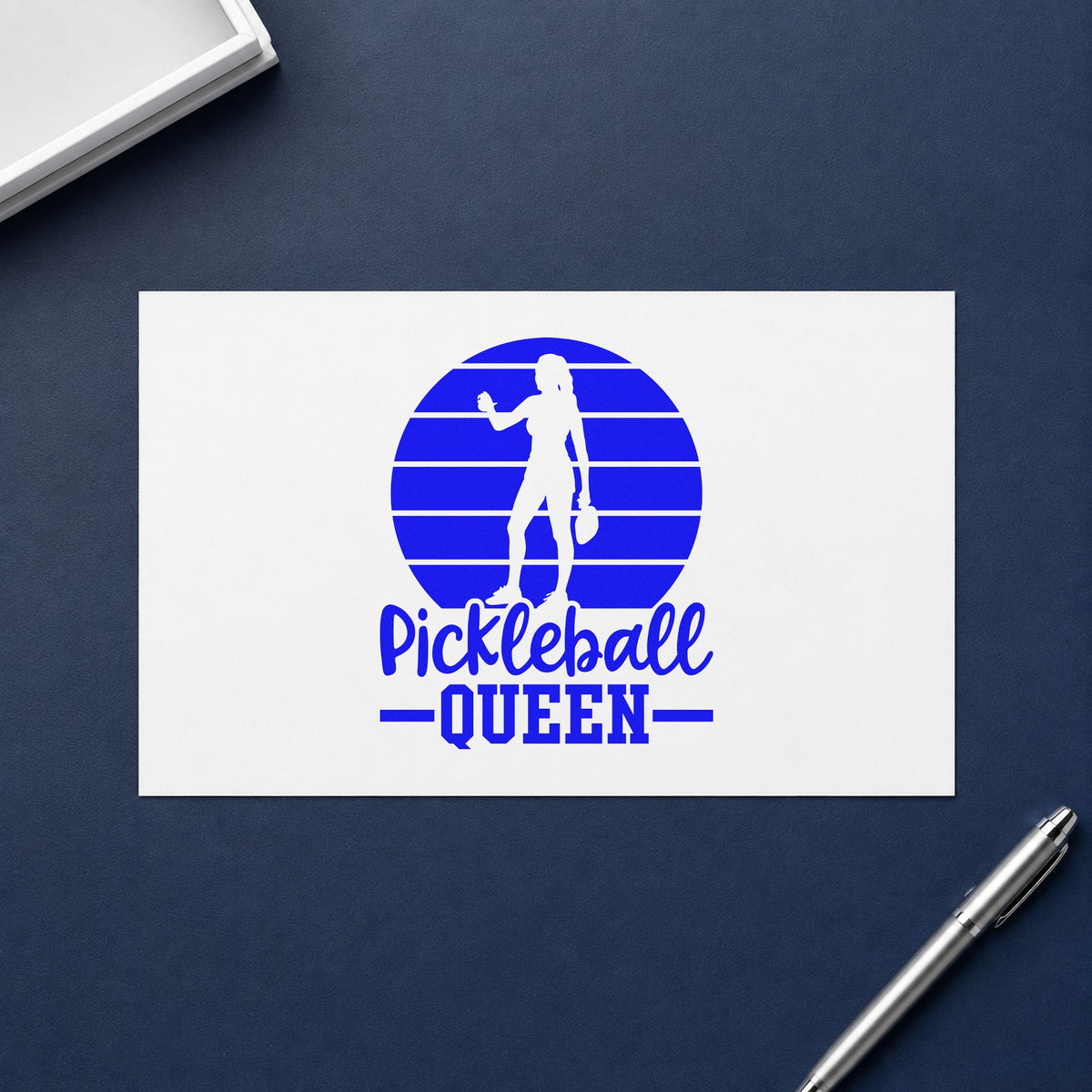 Pickleball Queen Player Silhouette craft stamp in blue ink on cardstock, an easy option for program tee printing.