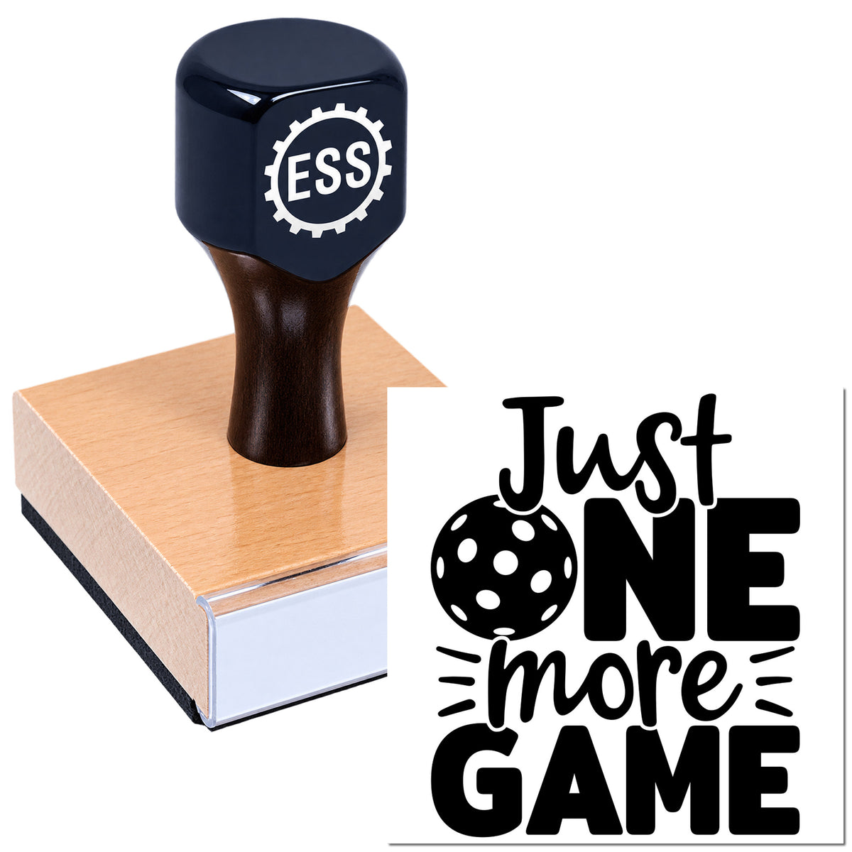 Dark blue ESS rubber stamp and seal pressing into a wooden block beside bold black "Just ONE more GAME" text.