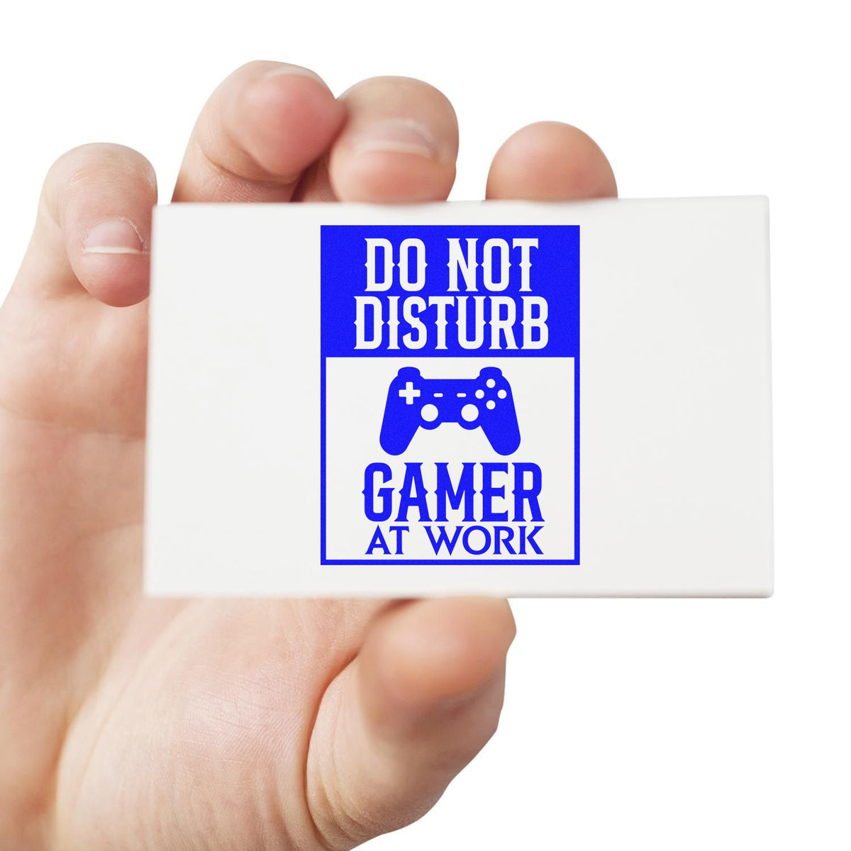 White stamp seal with blue Do Not Disturb Gamer at Work text and game controller icon, held in hand.