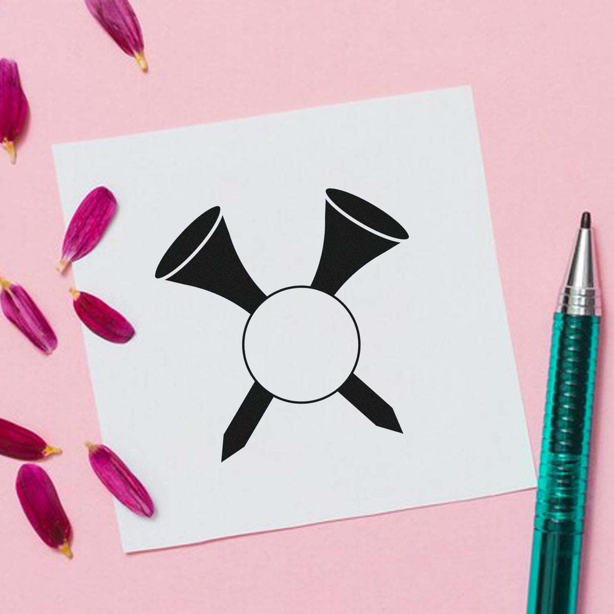 Black custom stamp and seal logo on white card, styled on a pink background with magenta petals and a teal pen.