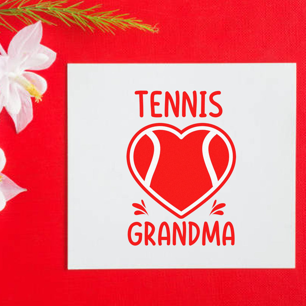 Red and white tennis grandma stamp seal with heart-shaped tennis graphic on a white square card, on a bright red floral background.
