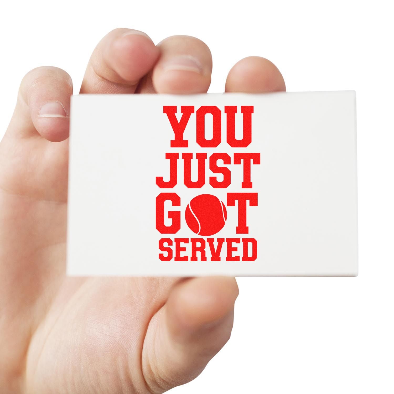 Hand holding a white stamp seal with bold red YOU JUST GOT SERVED and a tennis ball graphic.