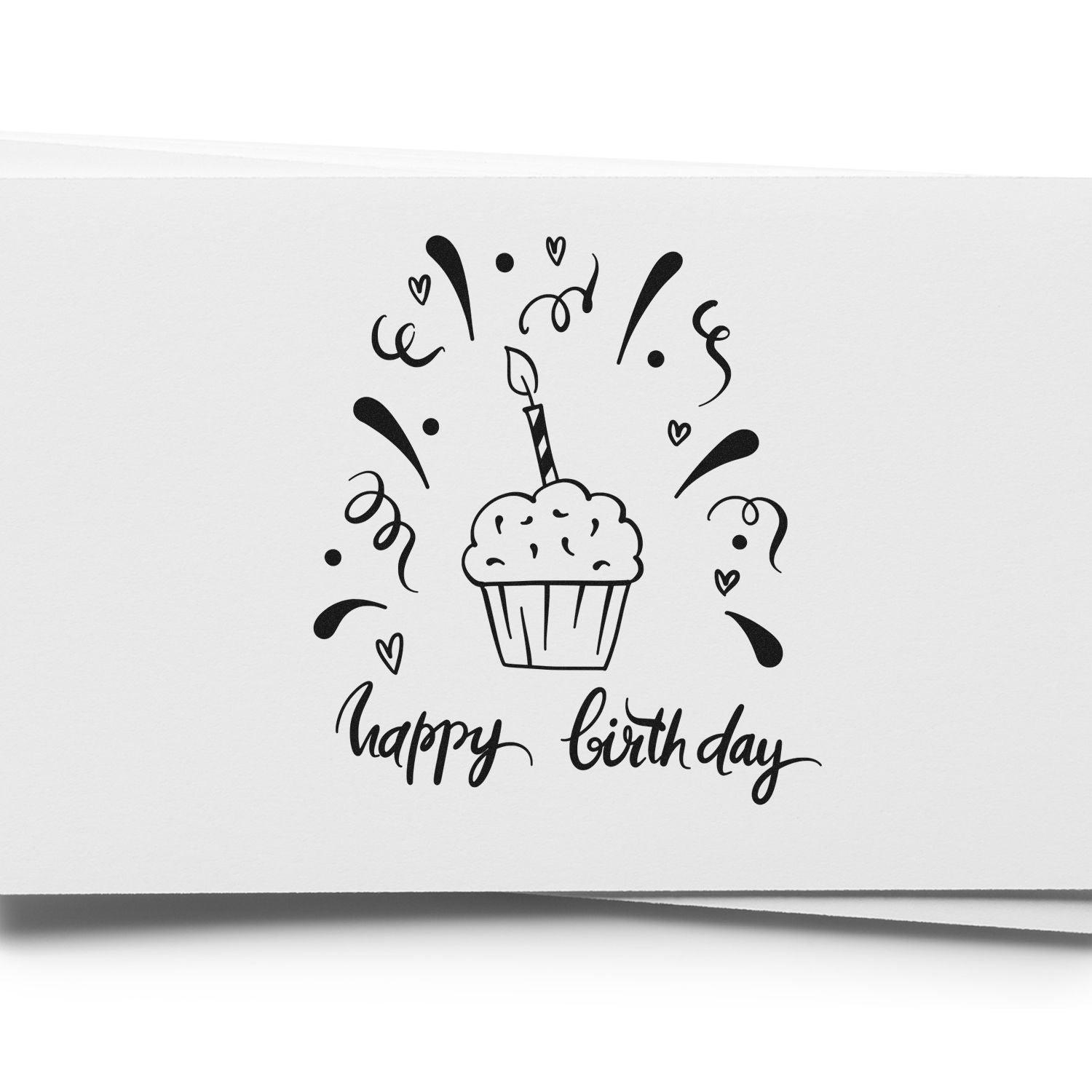 Black happy birthday stamp with cupcake, candle, hearts and confetti on white paper.