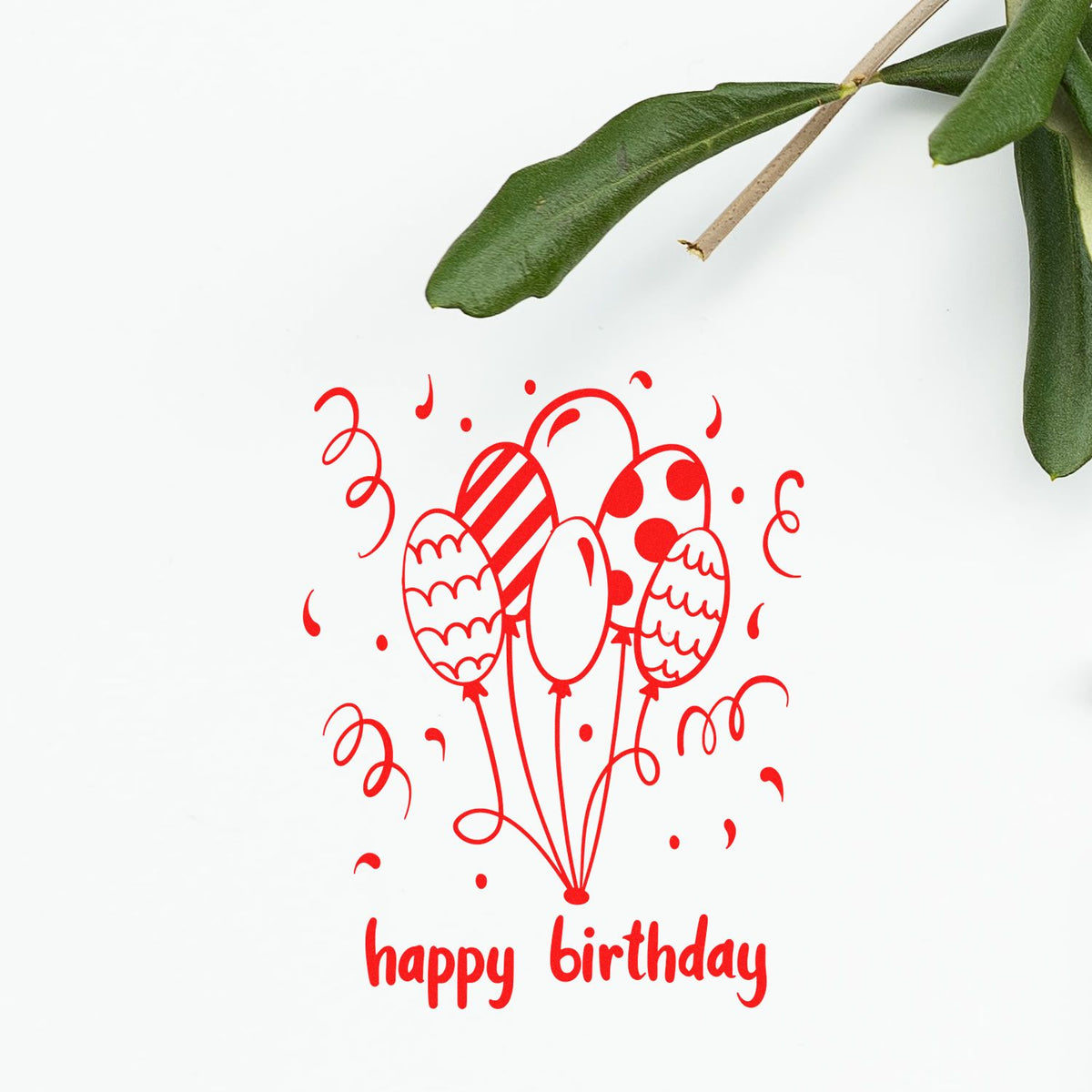 Red happy birthday balloon stamp seal with confetti on white background, accented by green leaves.
