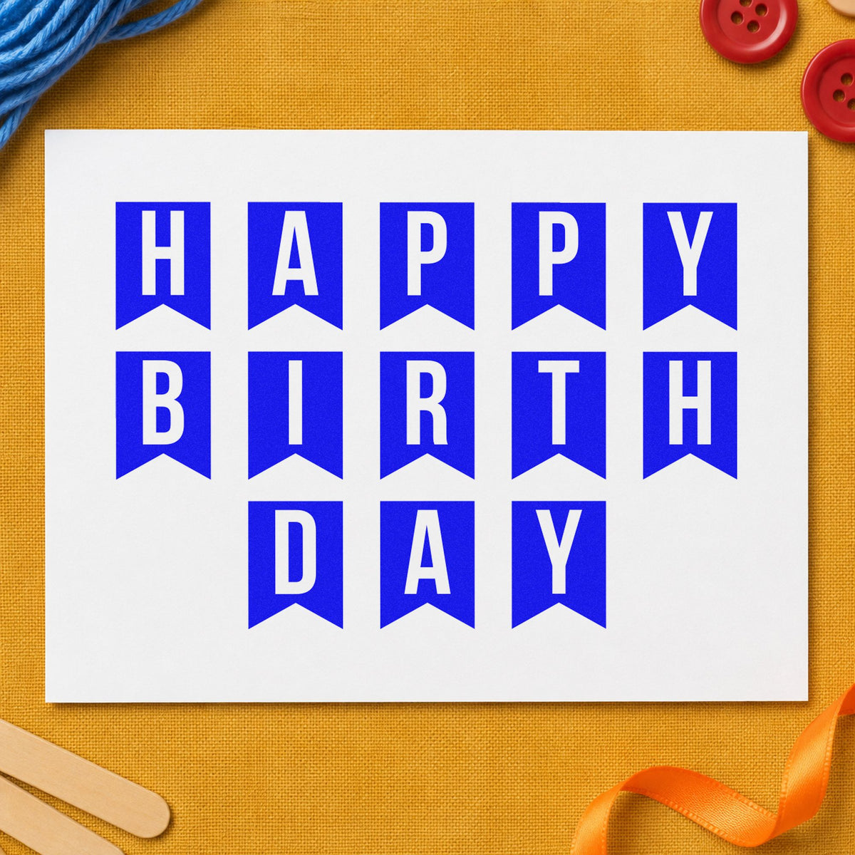 Happy Birthday Pennant Letters craft stamp in blue ink on cardstock, an easy option for van curtain printing.