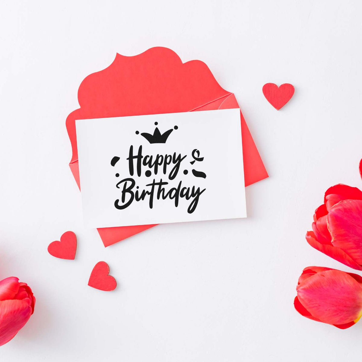 Happy Birthday stamp on white card with red wax-seal envelope, hearts, and pink petals.