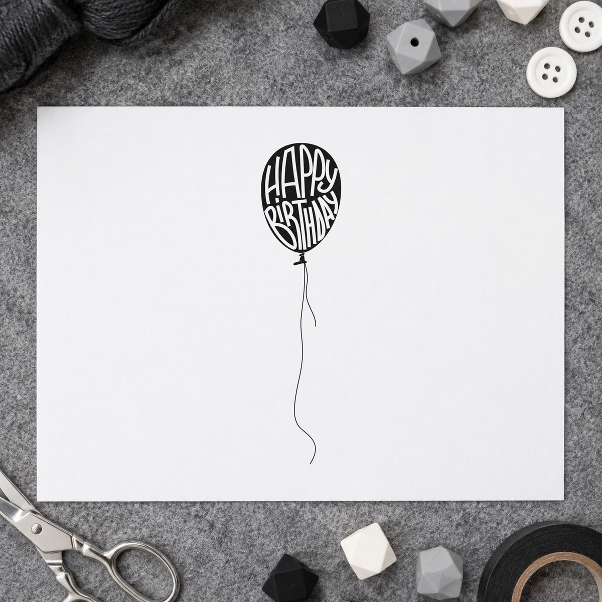 Happy Birthday Single Balloon craft stamp imprint in black ink on a handmade project, one idea being trail kit gift tags.