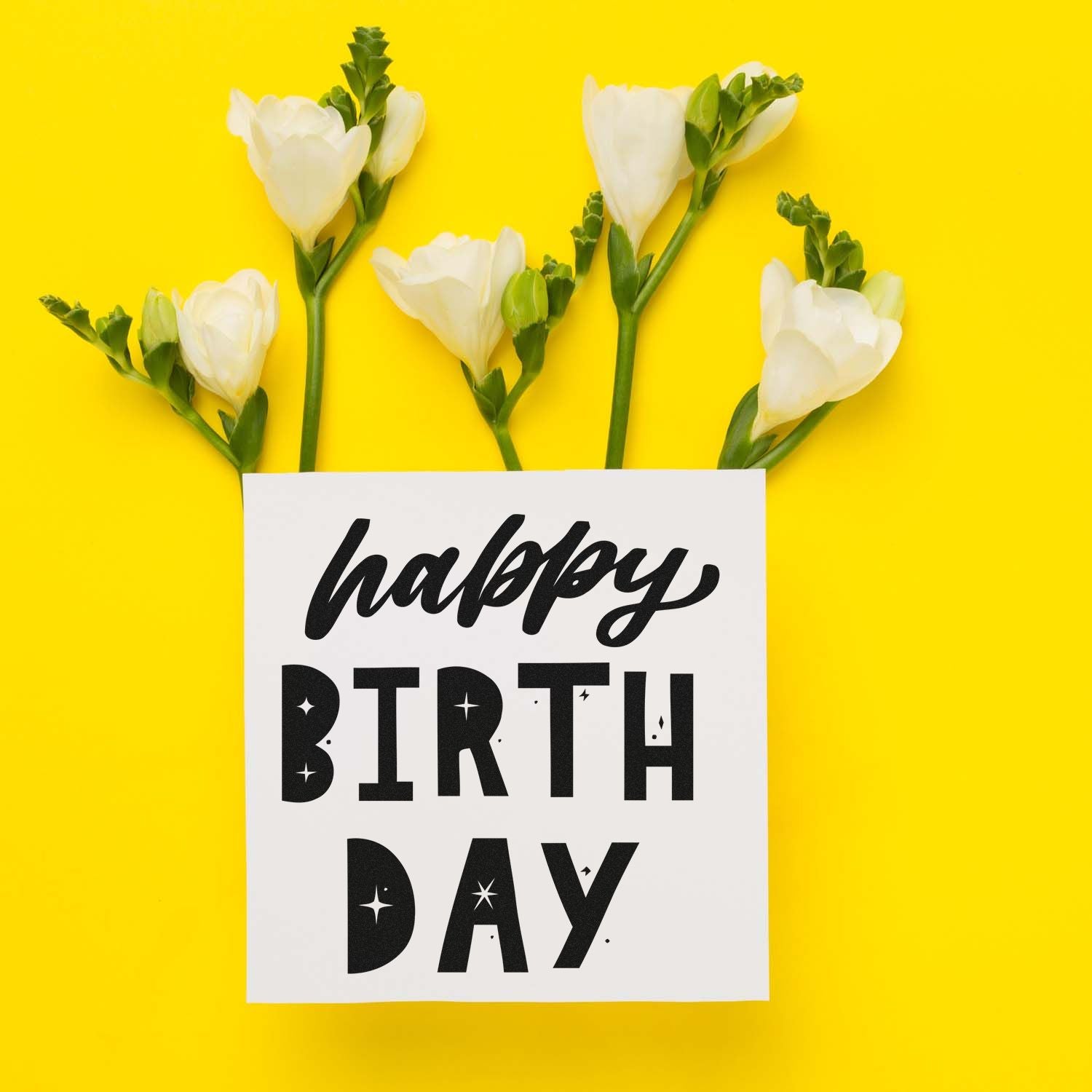 Happy Birthday stamp and seal card with black lettering, white flowers, and bright yellow background.