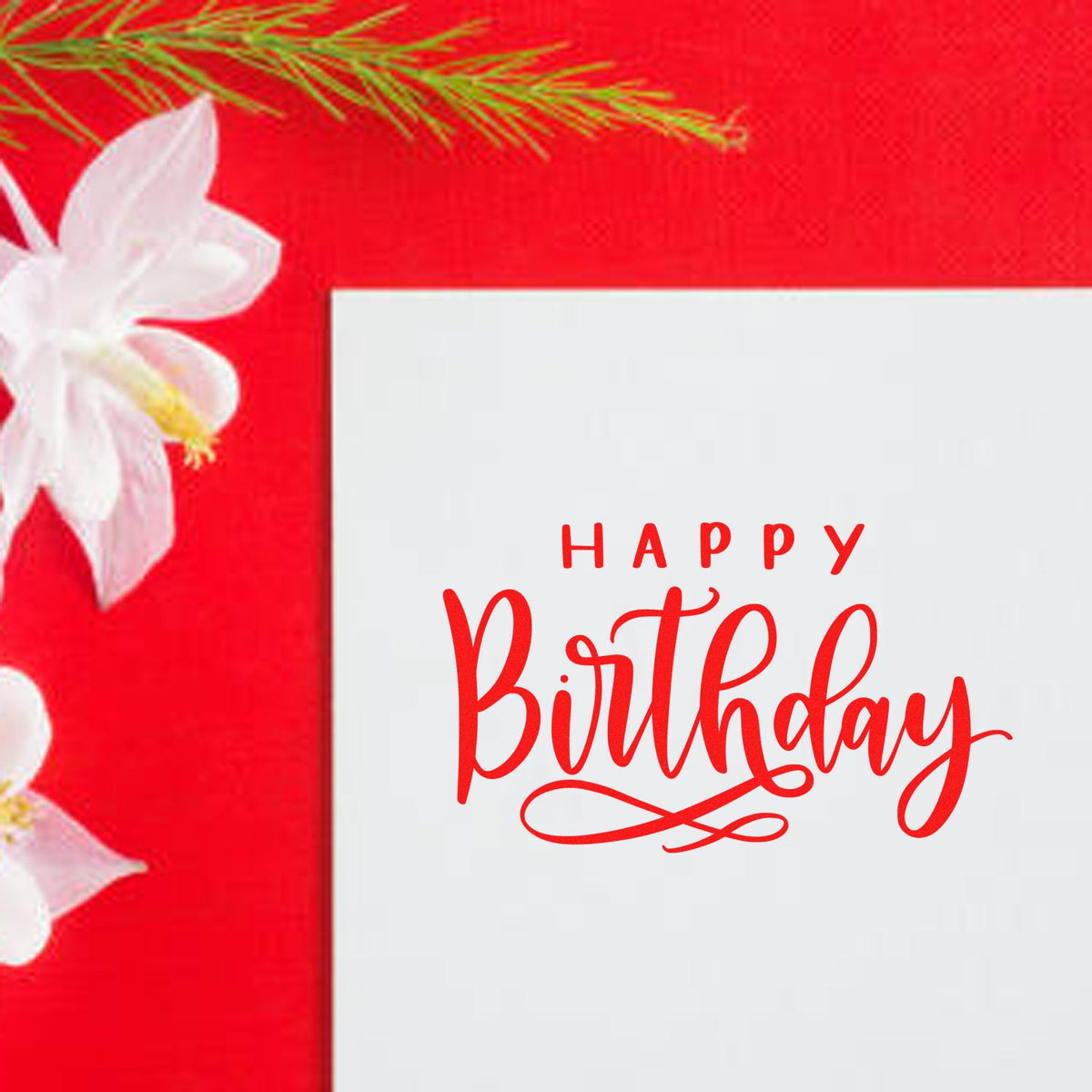 Red Happy Birthday stamp/seal on white card, set against a bright red floral background with white blossoms and greenery.