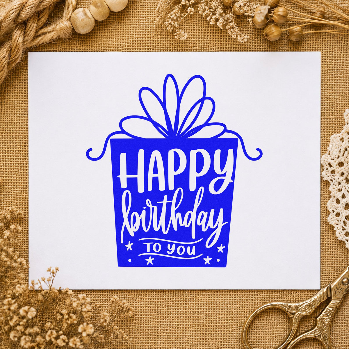 Birthday Gift Shaped Lettering craft stamp in blue ink on cardstock, an easy option for wrap cloth printing.
