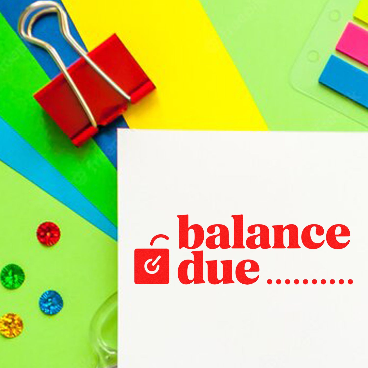 Red balance due stamp on white paper, with colorful stationery, binder clip, and seal products.
