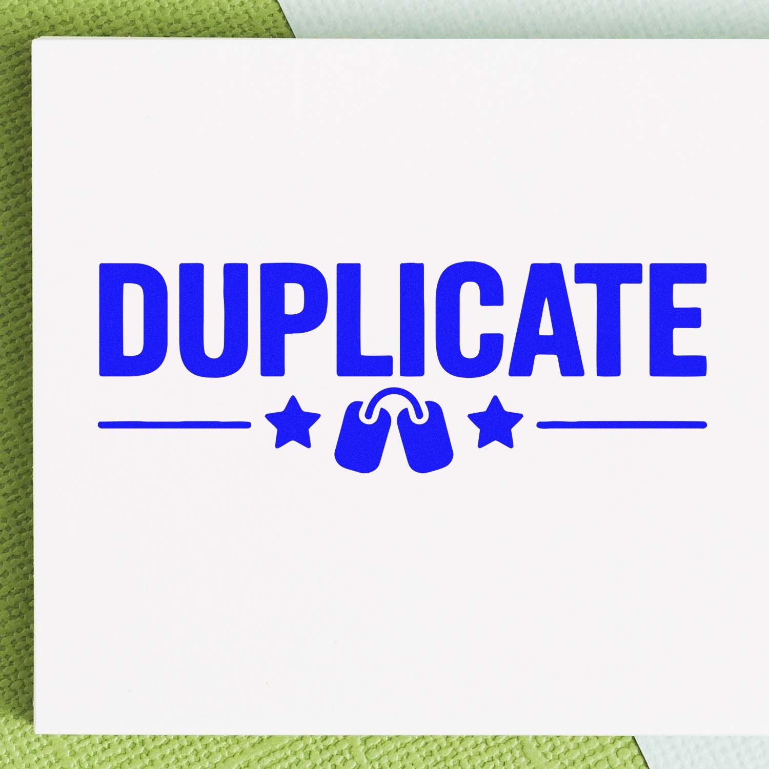 Blue DUPLICATE stamp with seal icon, stars and lines on a white card over green textured background.