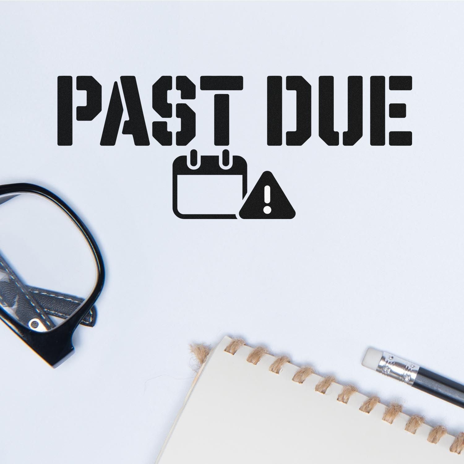 Black PAST DUE stamp and seal design with calendar warning icon on white paper, beside office supplies.