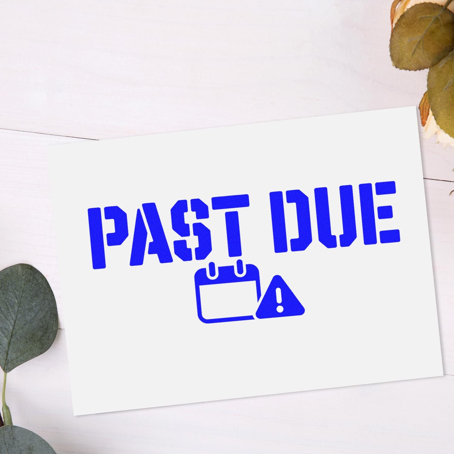 Blue PAST DUE stamp with calendar warning icon on white card, framed by soft green leaves.