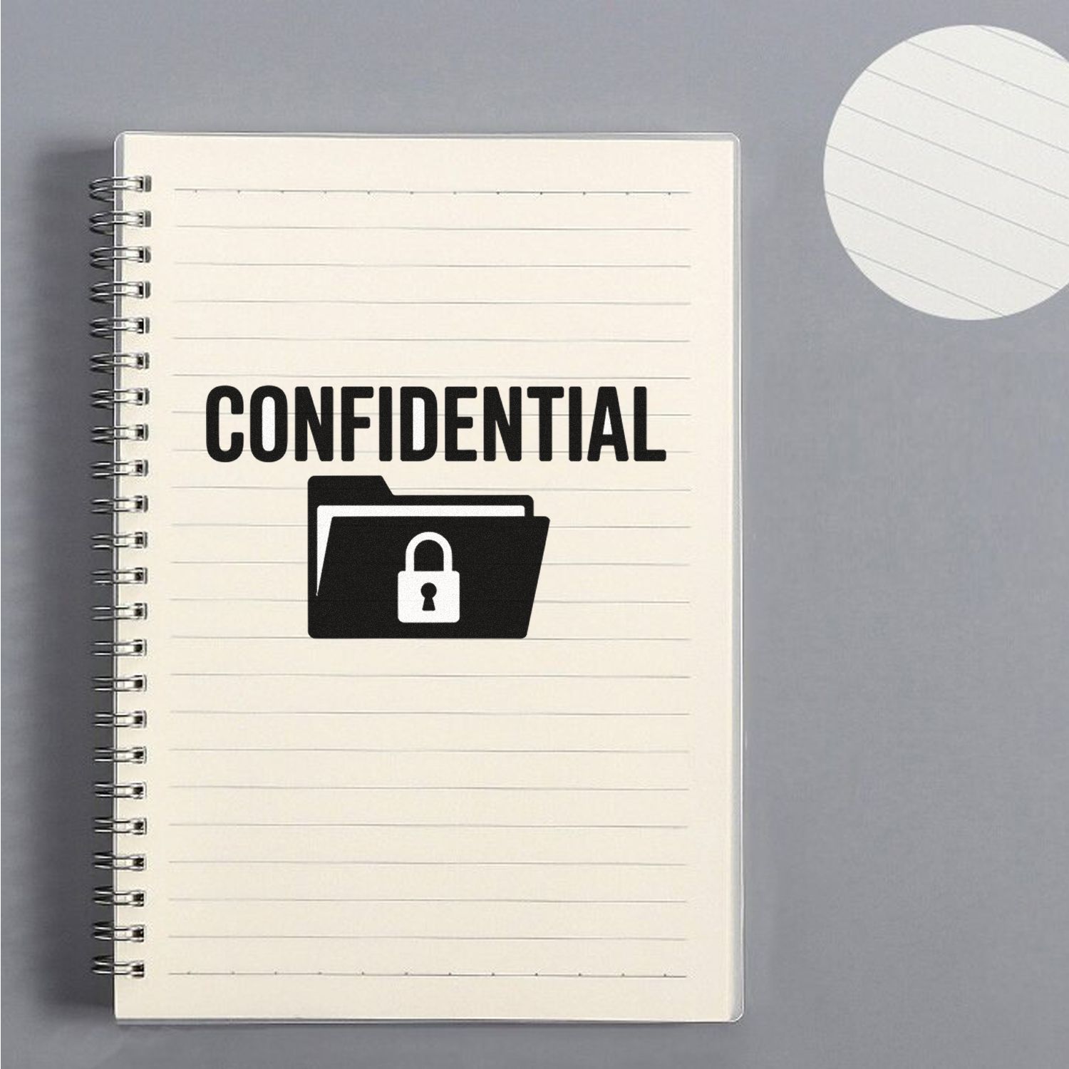 Black confidential stamp and lock seal on a cream spiral notebook with lined paper, against a gray background.