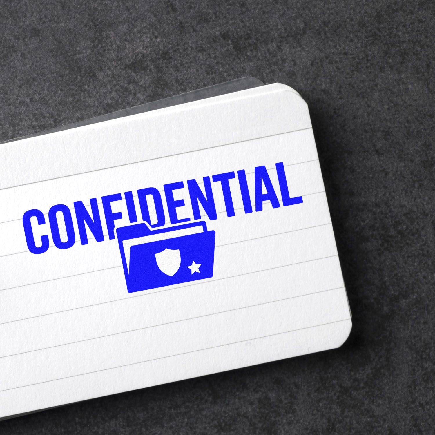 Blue confidential stamp and seal with shield folder icon on a white lined card against a dark background
