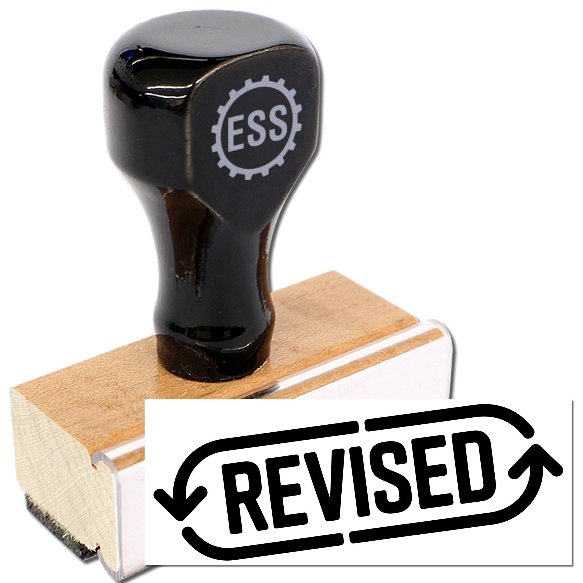 Black ESS rubber stamp on wooden block with white REVISED seal label and bold black lettering.