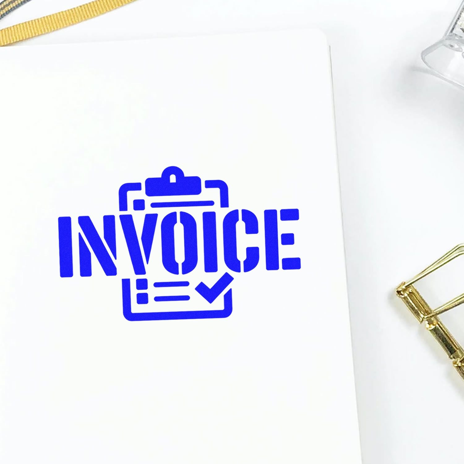 Blue invoice stamp and seal on white paper with clipboard and checkmark, accented by gold binder clip.