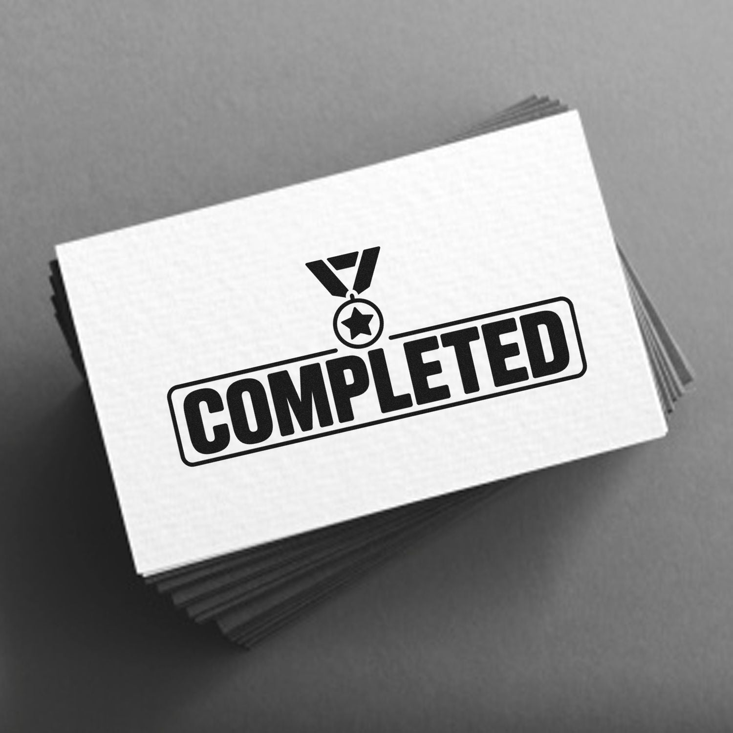 Black COMPLETED stamp seal on white card stack with medal icon, set against a gray background.