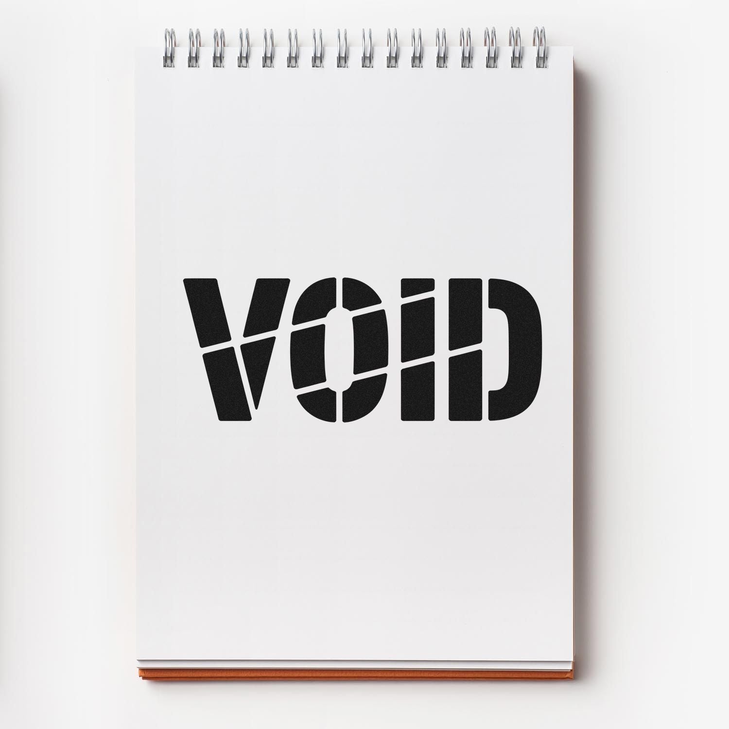 White spiral notebook with bold black VOID security stamp and seal, silver binding, on a clean white background.