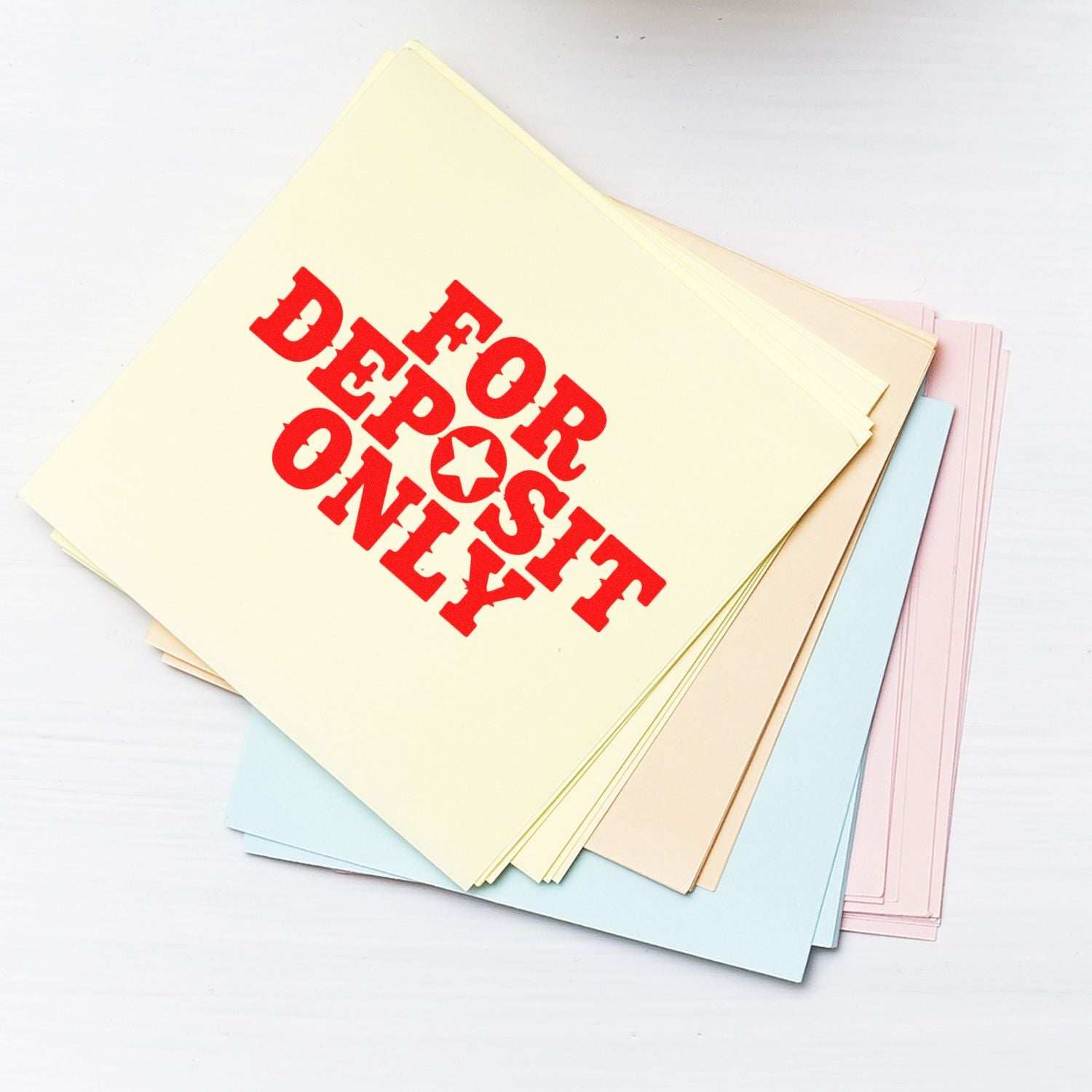 Pastel stamp and seal sheets stacked on white, with red FOR DEPOSIT ONLY imprint on cream paper.