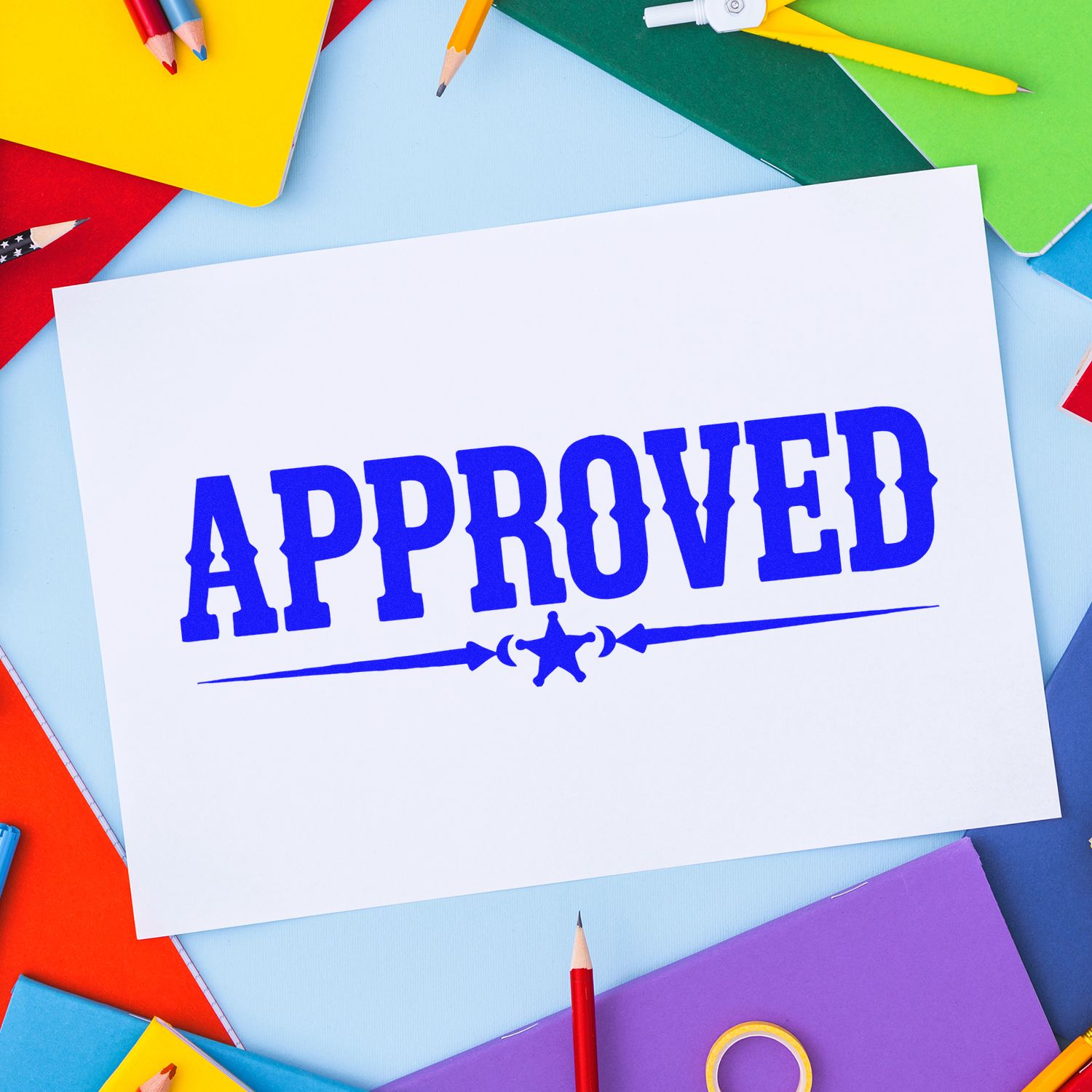 Blue APPROVED stamp on white paper, surrounded by colorful notebooks and pencils, showcasing stamp and seal products.