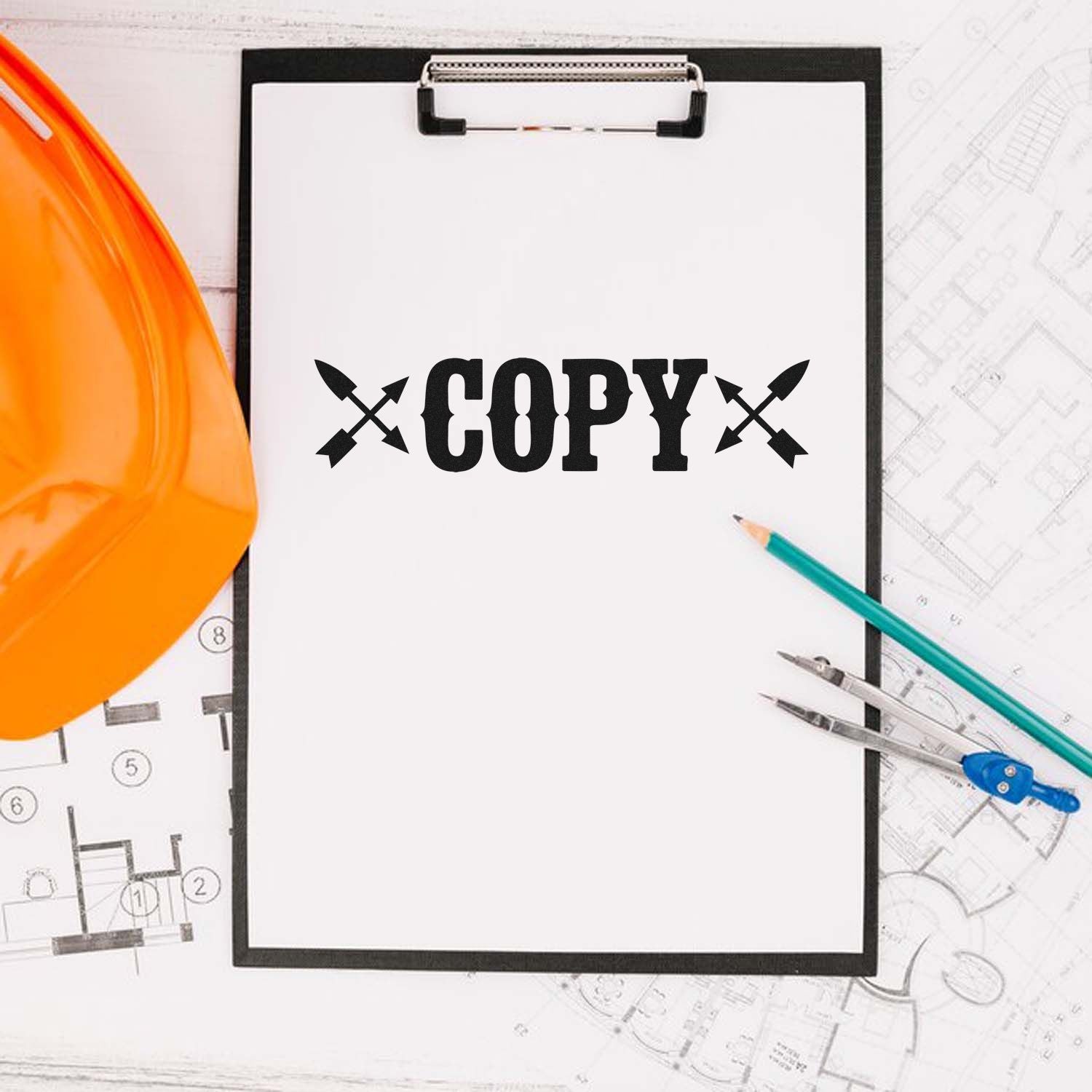 Black copy stamp and seal on clipboard with orange hard hat, pencils, and blue drafting compass over blueprints.
