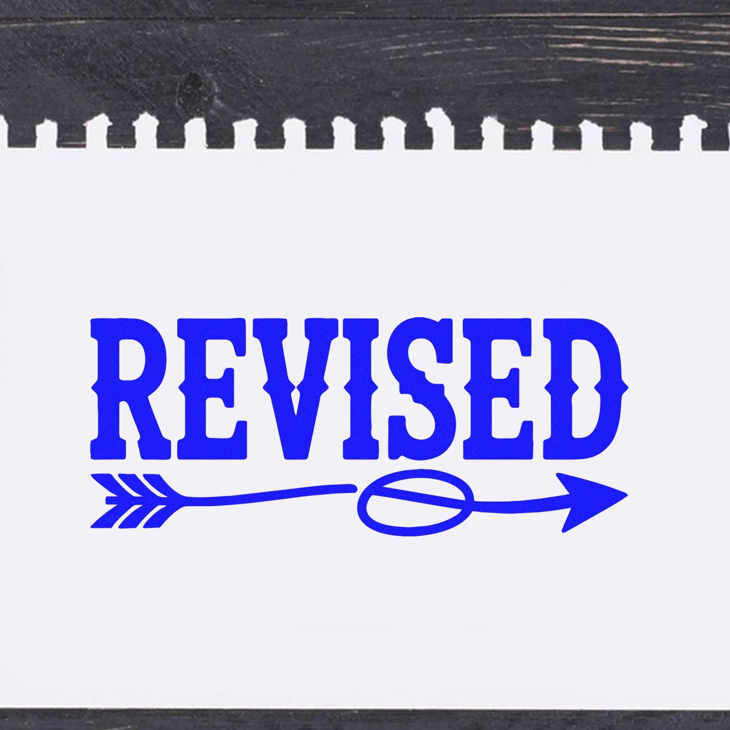 Blue REVISED document stamp with arrow on white paper, black inked edges, for stamp and seal products.