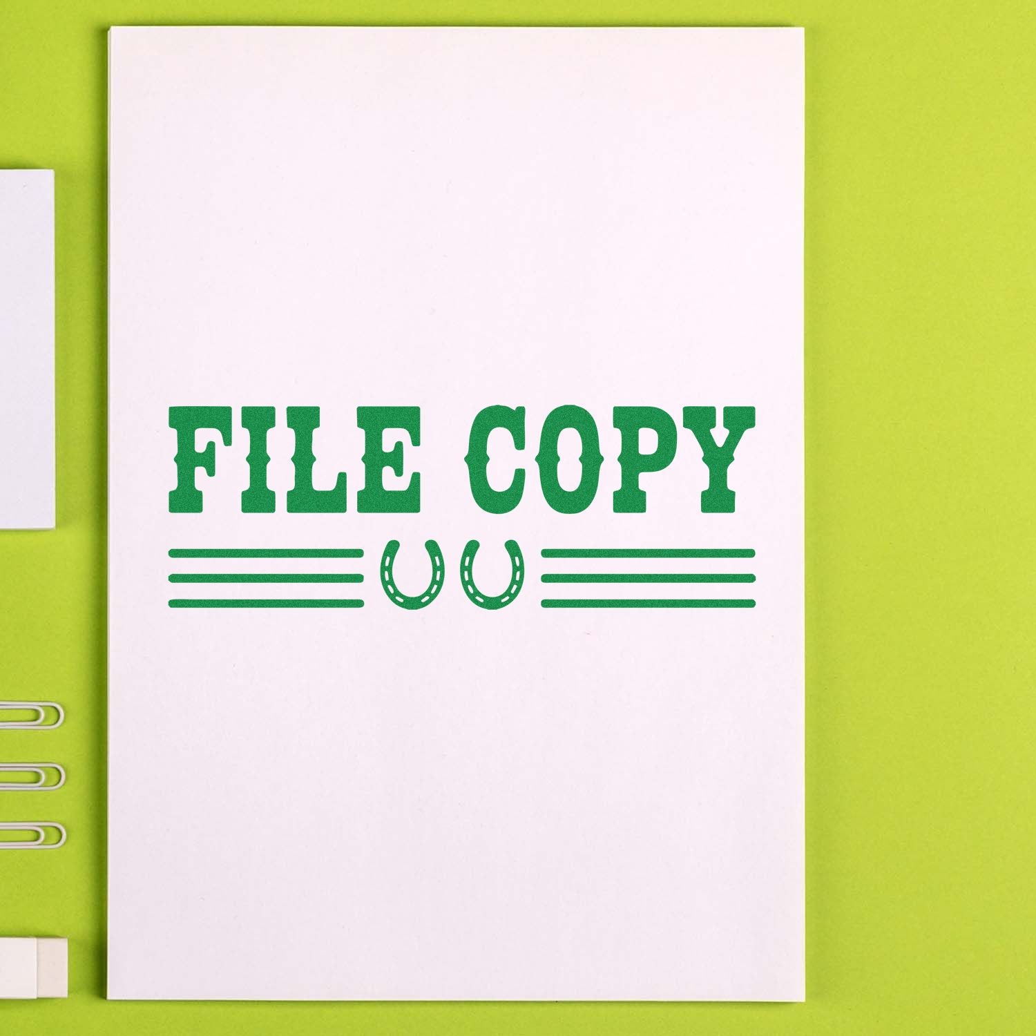 Green FILE COPY stamp and seal design with horseshoe icons and lines on a white sheet over a lime background.