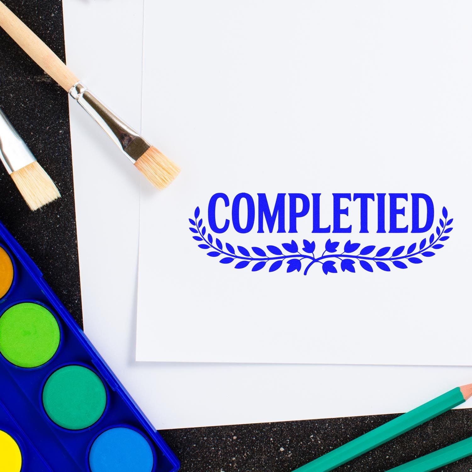 Blue COMPLETED seal stamp on white paper, with laurel, paintbrushes, and colorful watercolor palette.