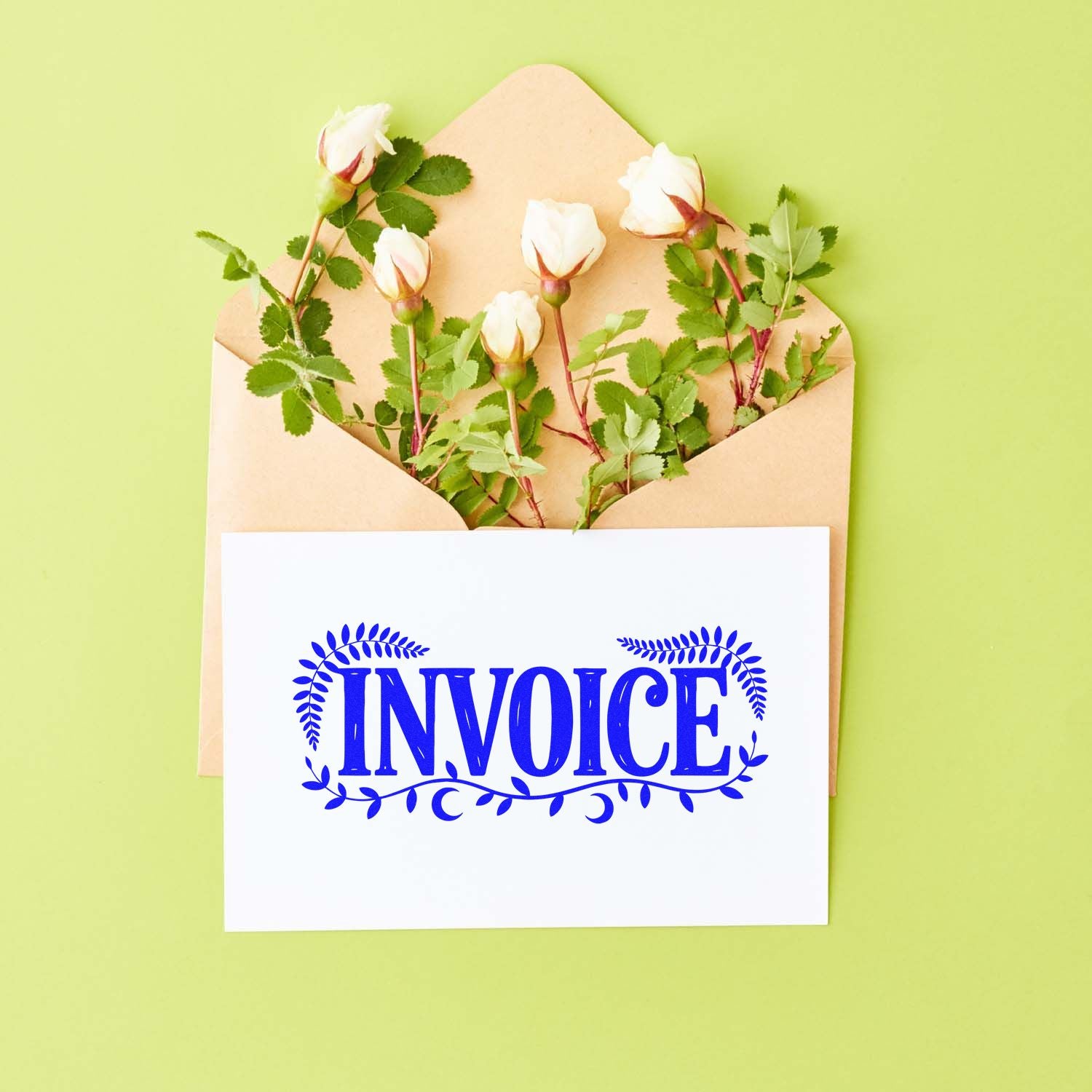 Envelope with white roses and blue floral invoice stamp seal on a white card against a light green background.