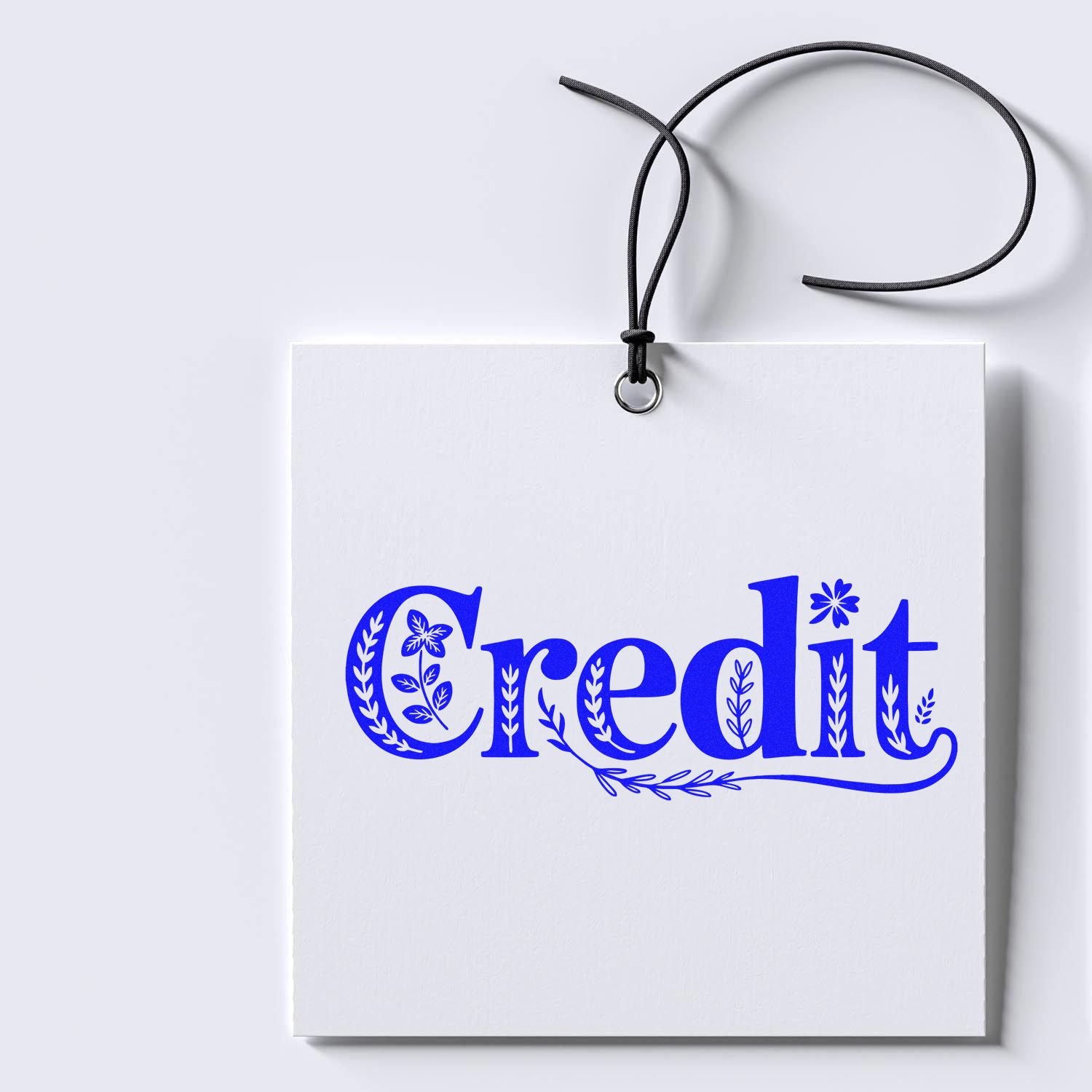 White hanging tag with blue decorative Credit text, black cord, for custom stamp and seal products.