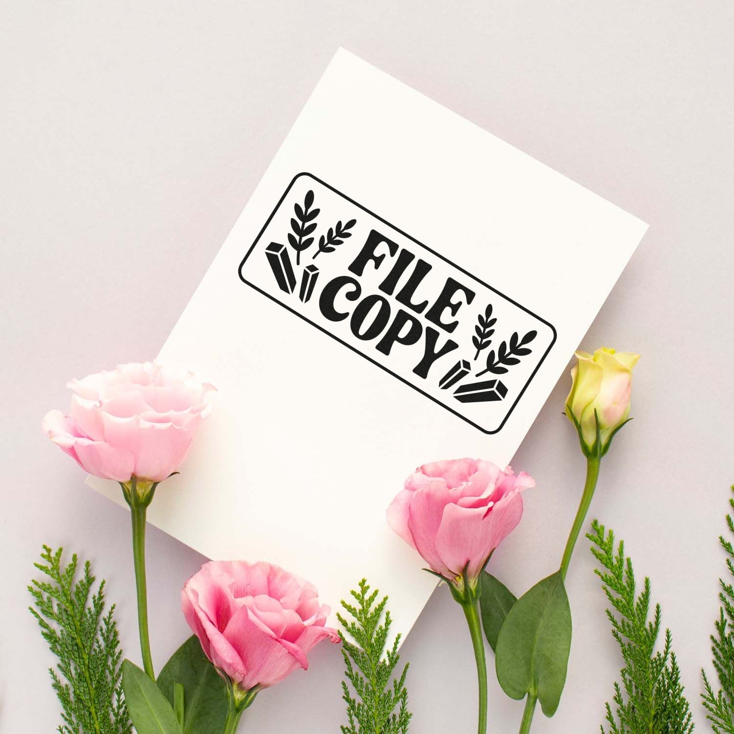 Black FILE COPY stamp seal on white card with floral icons, surrounded by pink flowers and green foliage.