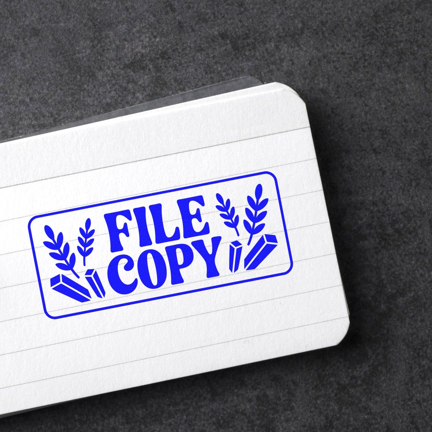 Blue FILE COPY rubber stamp seal with leaf and crystal icons on white lined paper.