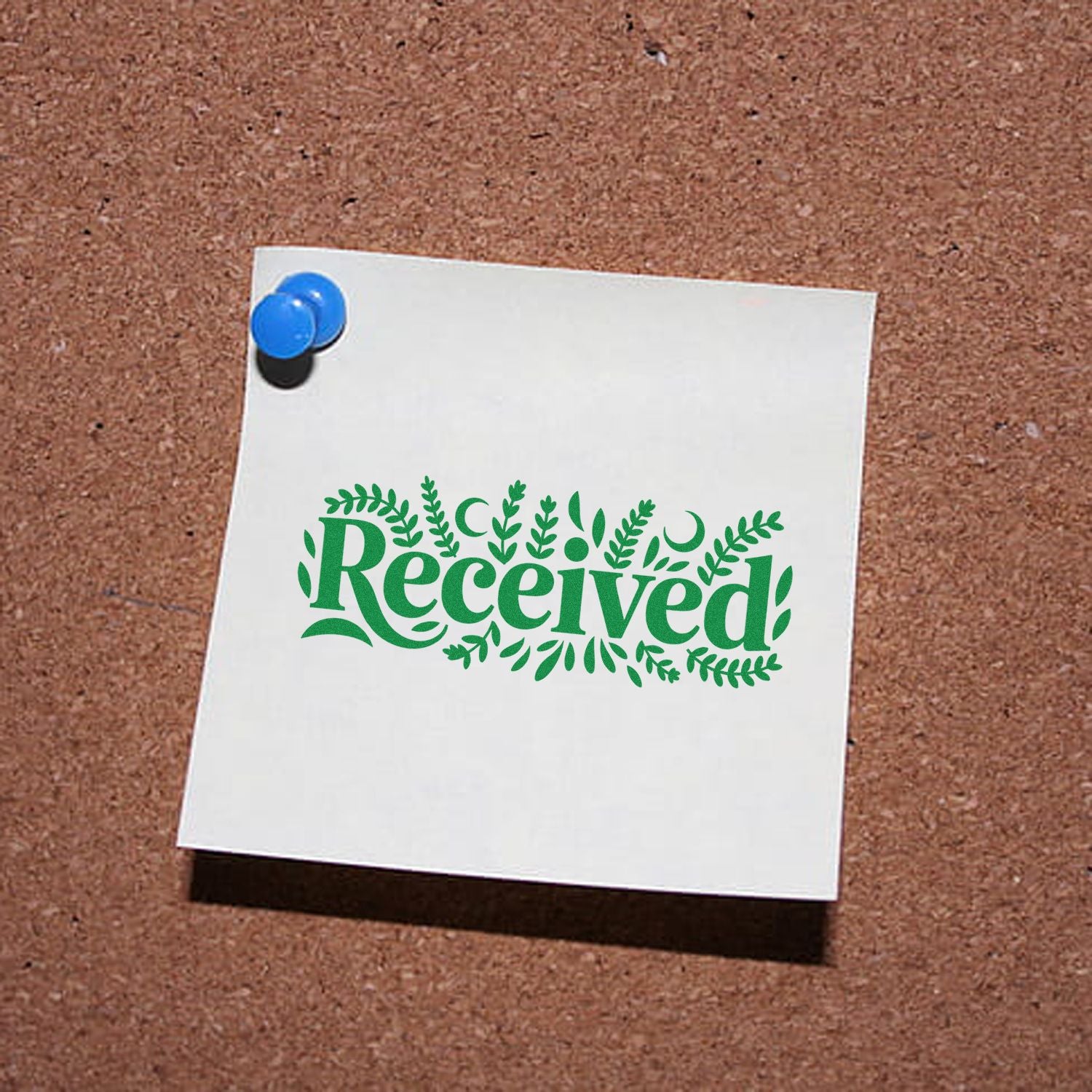 White note with green decorative Received rubber stamp and blue pushpin on corkboard.