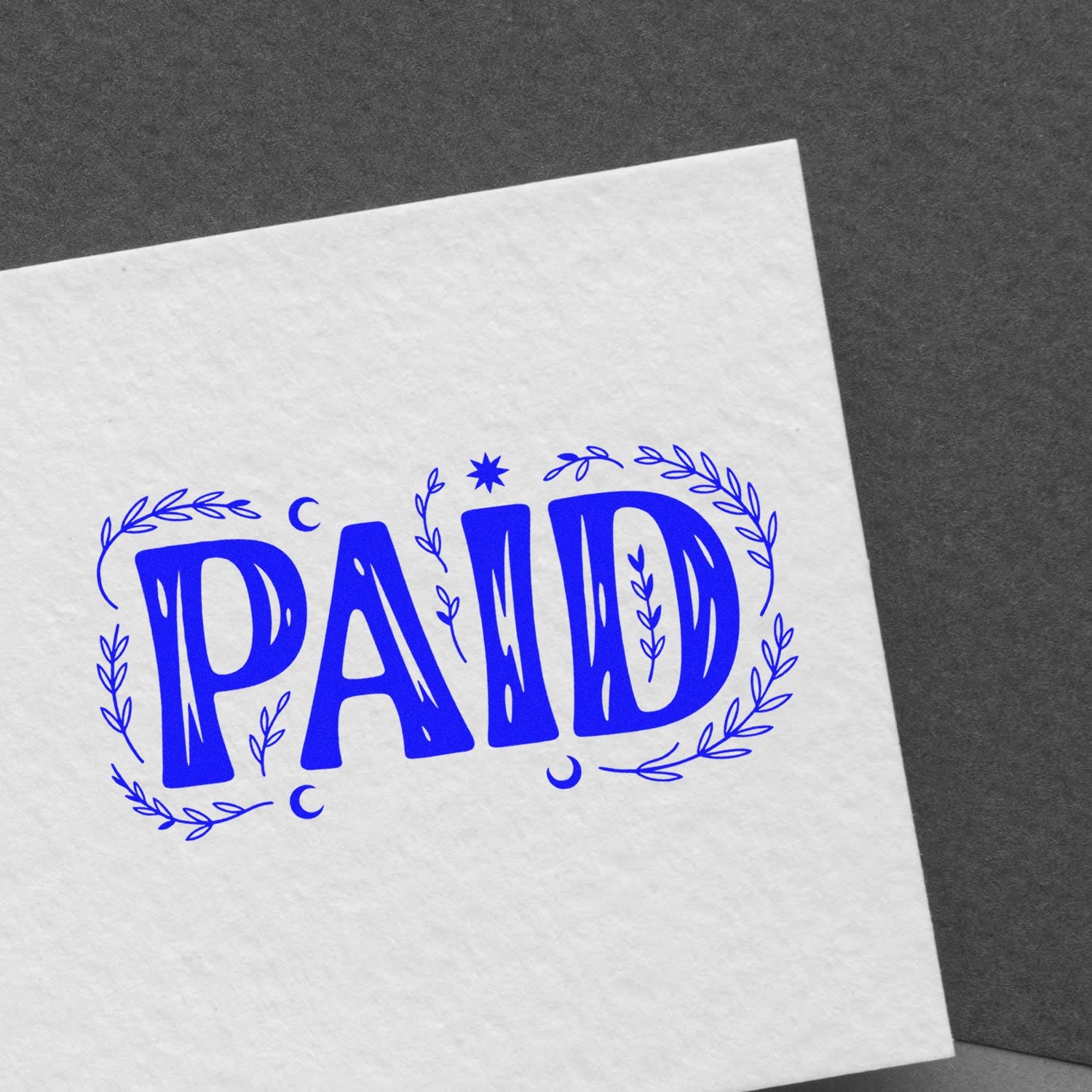 Blue PAID stamp seal with laurel wreath, printed in blue on white paper against a dark gray background.