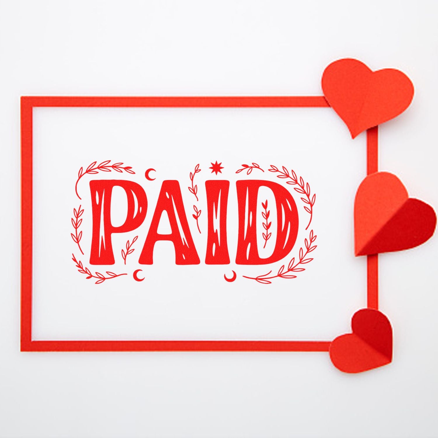 Red PAID stamp with decorative leaves in a red frame, accented by layered red heart seal stickers on a white background.