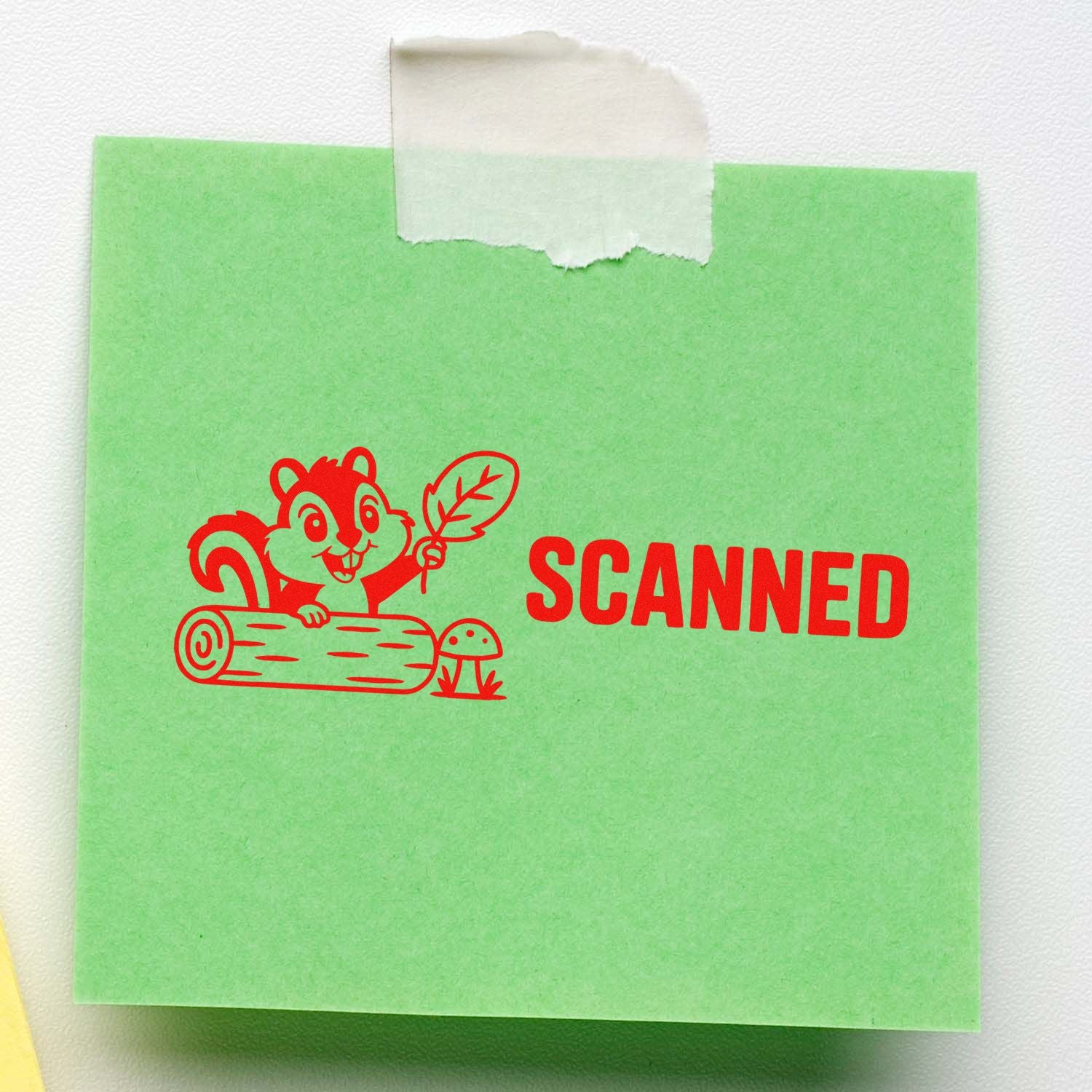 Green note with red SCANNED rubber stamp and squirrel seal graphic, taped at the top.