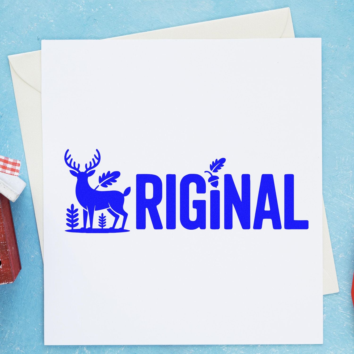 Blue RIGiNAL stamp seal with deer and oak leaves on a white card, set against a light blue background.