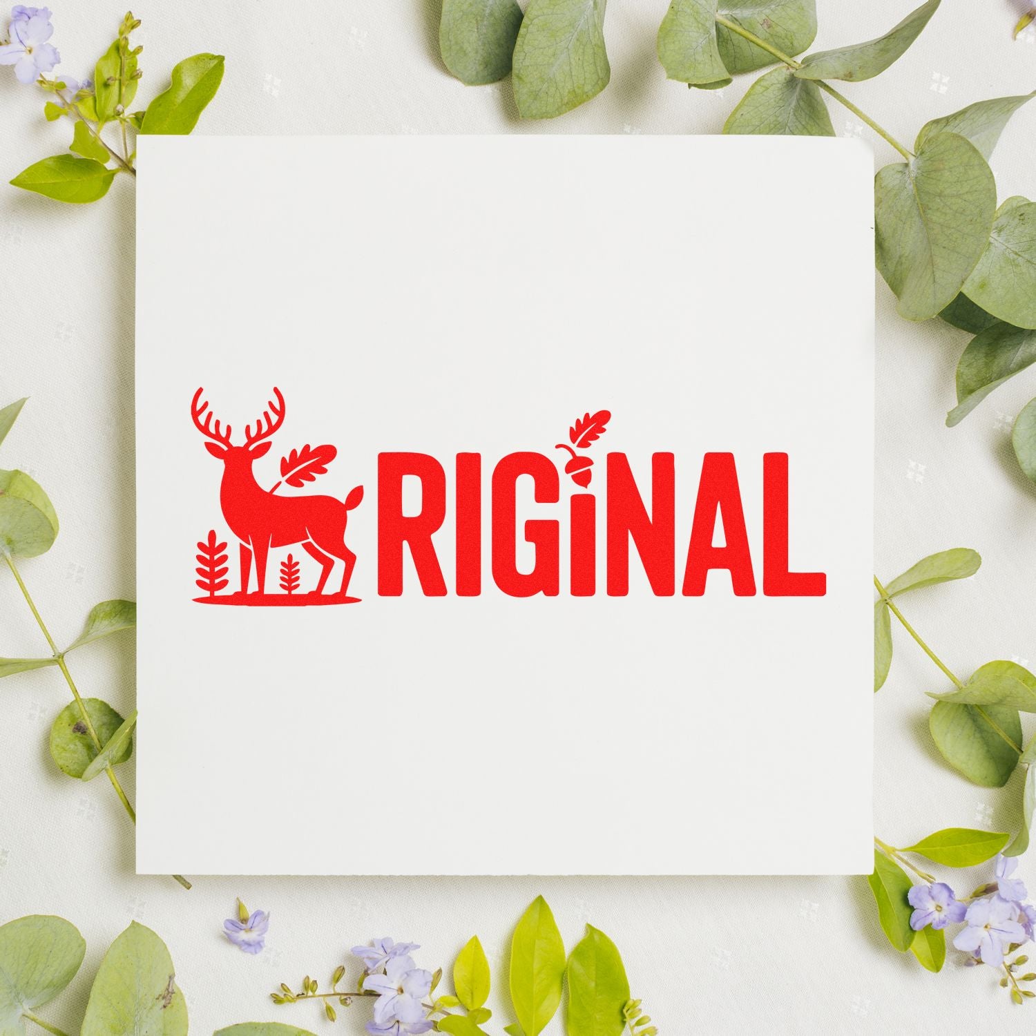 Red deer seal stamp logo and bold red RIGINAL text on a white card, framed by green leaves and small purple flowers.