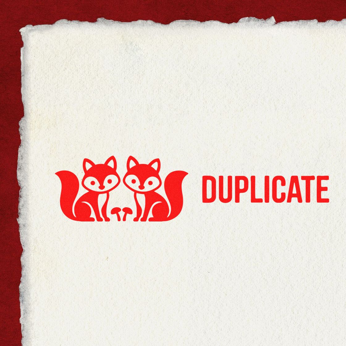 Red duplicate stamp seal with twin fox logo on textured white paper and deep red background.